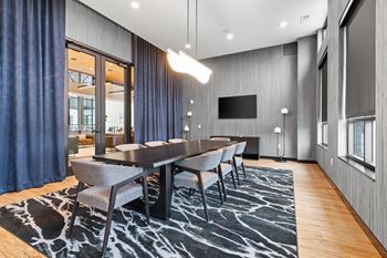 a conference room with a long wooden table and chairs